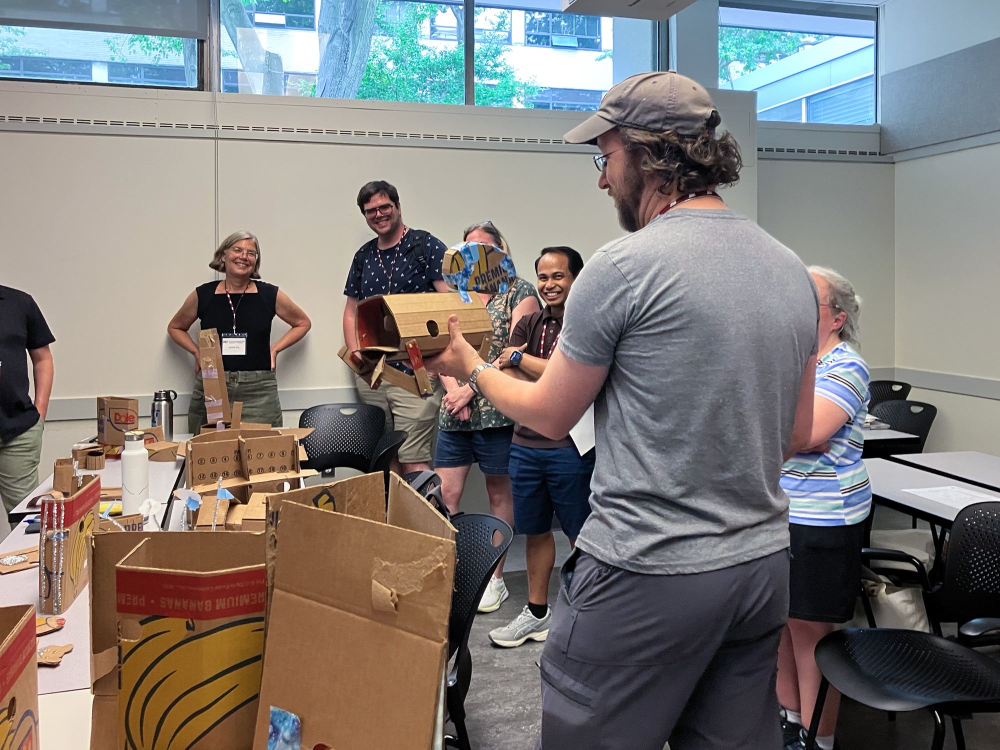 Teachers participating in a workshop and showing cardboard prototypes. 